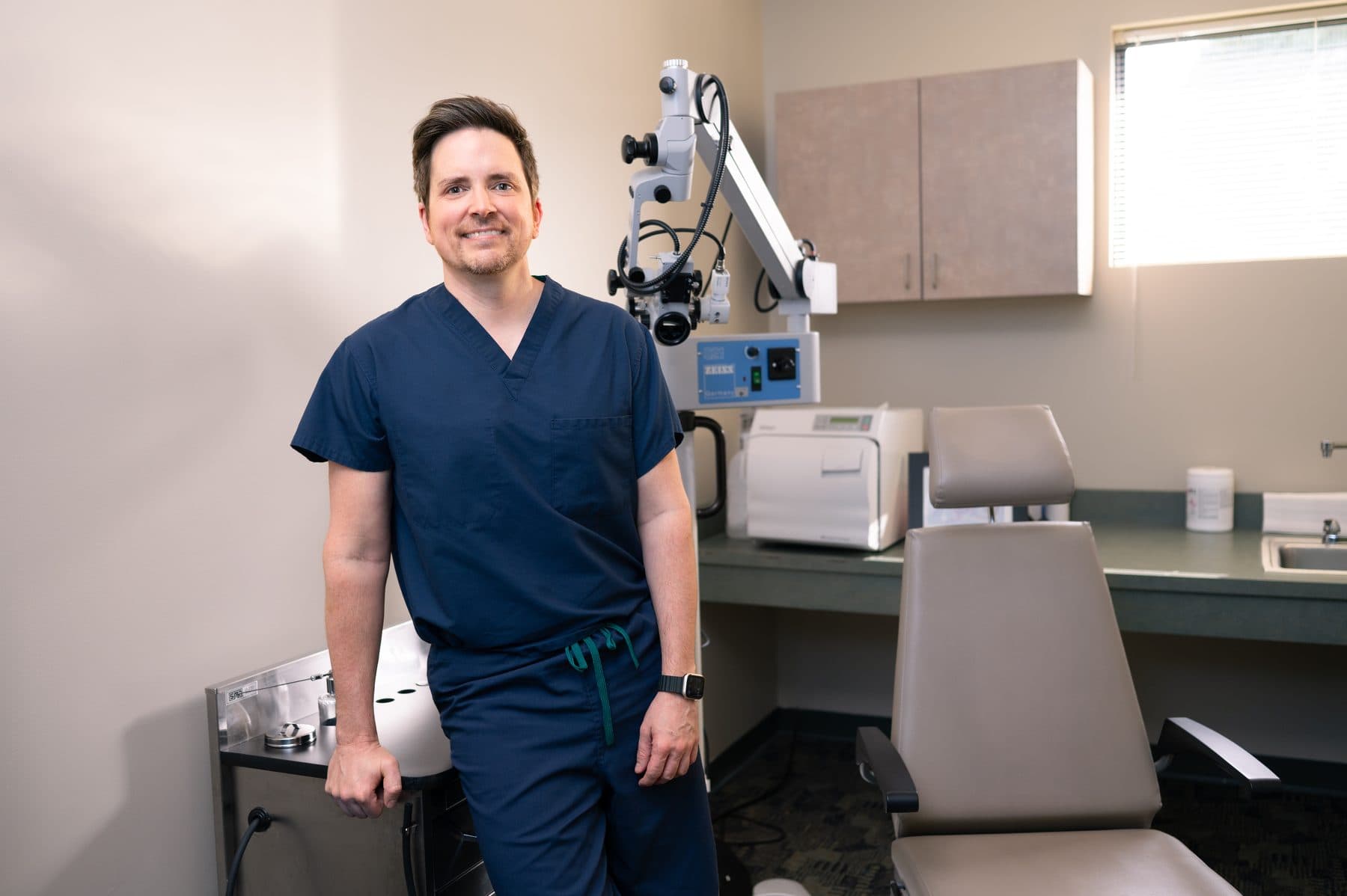 Dr. Chad Ruffin in scrubs in the exam room