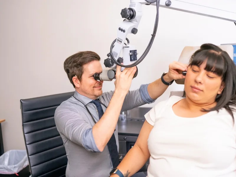 Dr. Ruffin examining a patient with a microscope